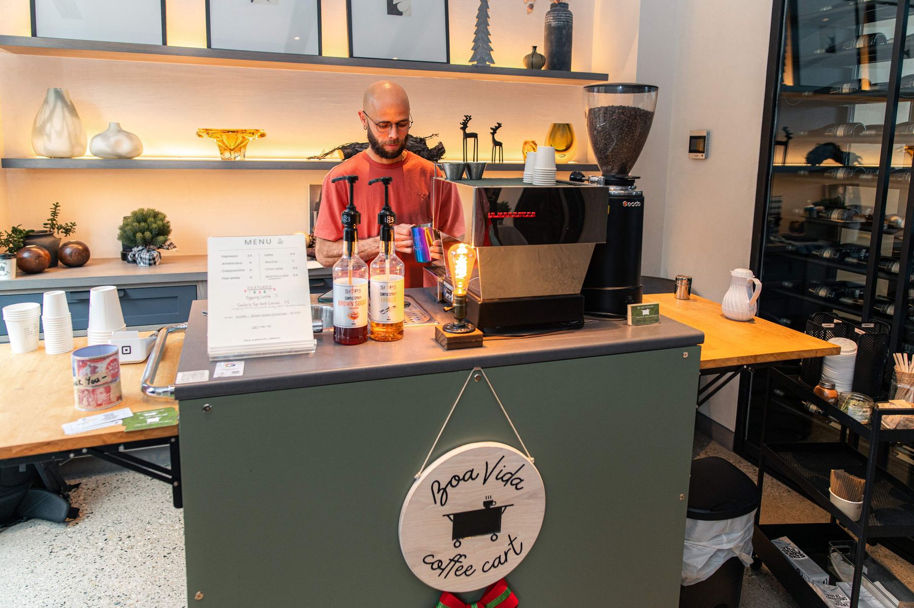 A Boa Vida barista making espresso at the mobile coffee cart set up for an event