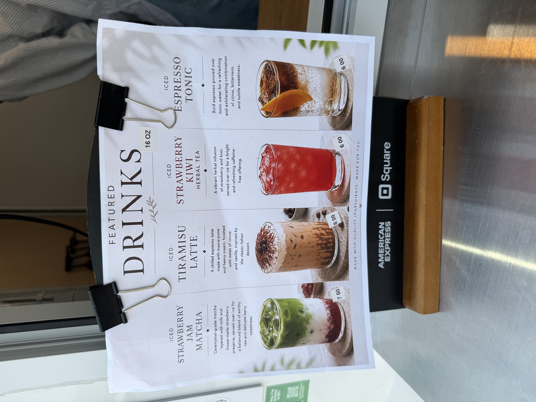 Boa Vida Coffee's featured drinks board showing iced strawberry jam matcha, tiramisu latte, strawberry kiwi herbal tea and espresso tonic